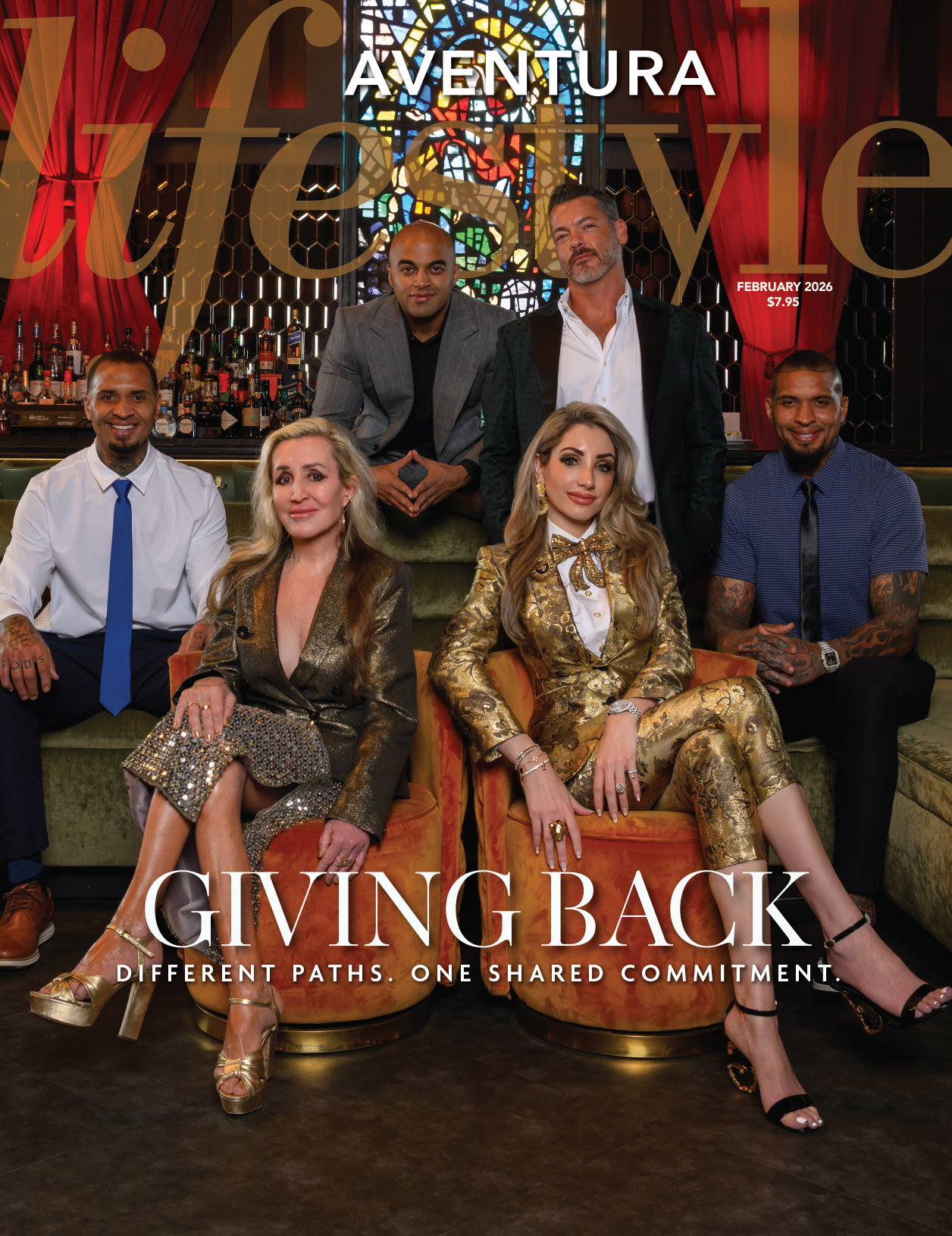Six well-dressed people gather in a stylish lounge with a green sofa and colorful lighting on the February 2026 cover of Aventura Lifestyle. The headline reads, “GIVING BACK: Different paths. One shared commitment.”. Lifestyle