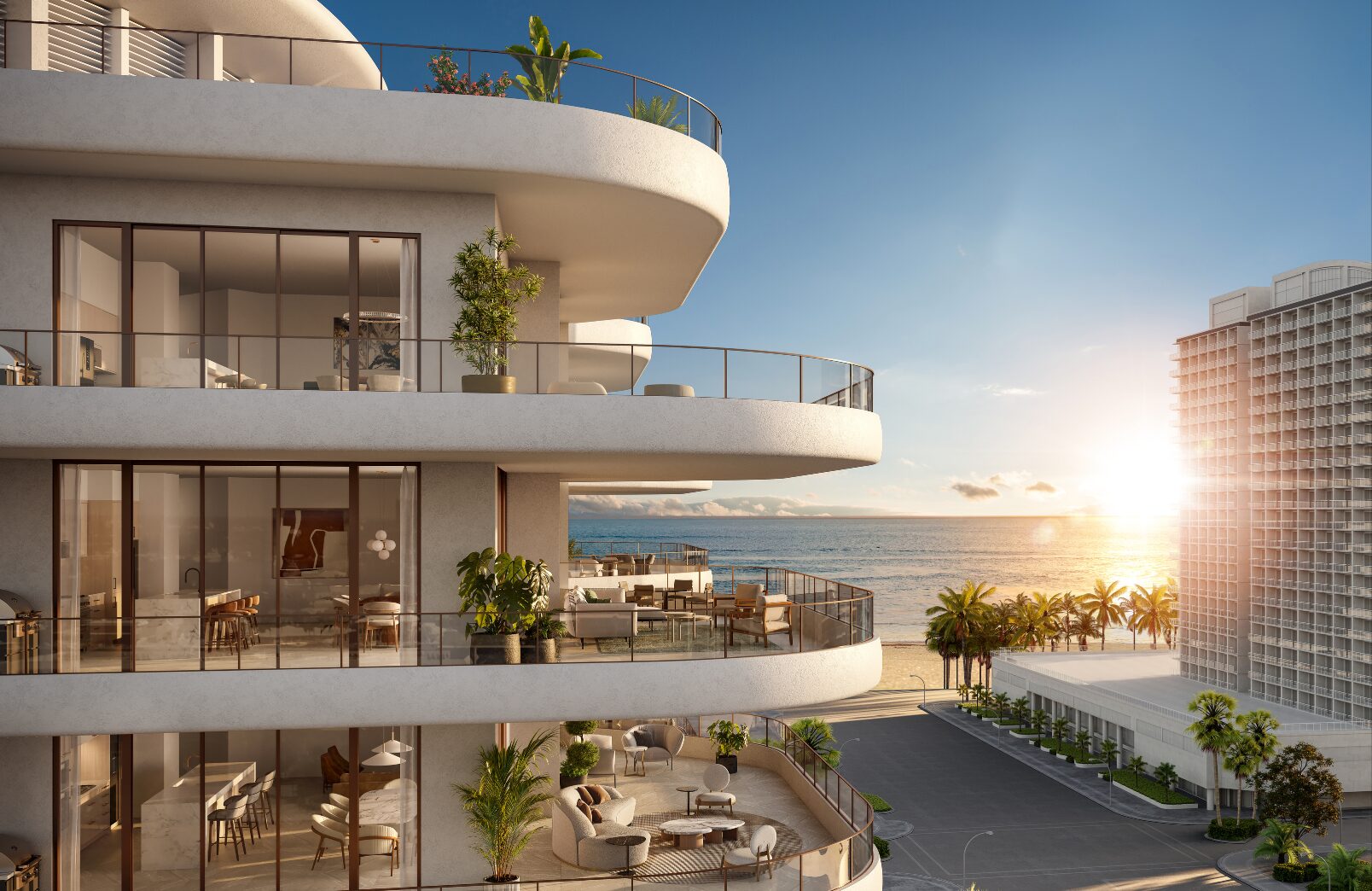 Modern beachfront apartment building with large balconies and glass railings, overlooking the ocean and palm trees at sunset. The sky is clear, and sunlight reflects off the water and nearby boutique hotel buildings. Lifestyle
