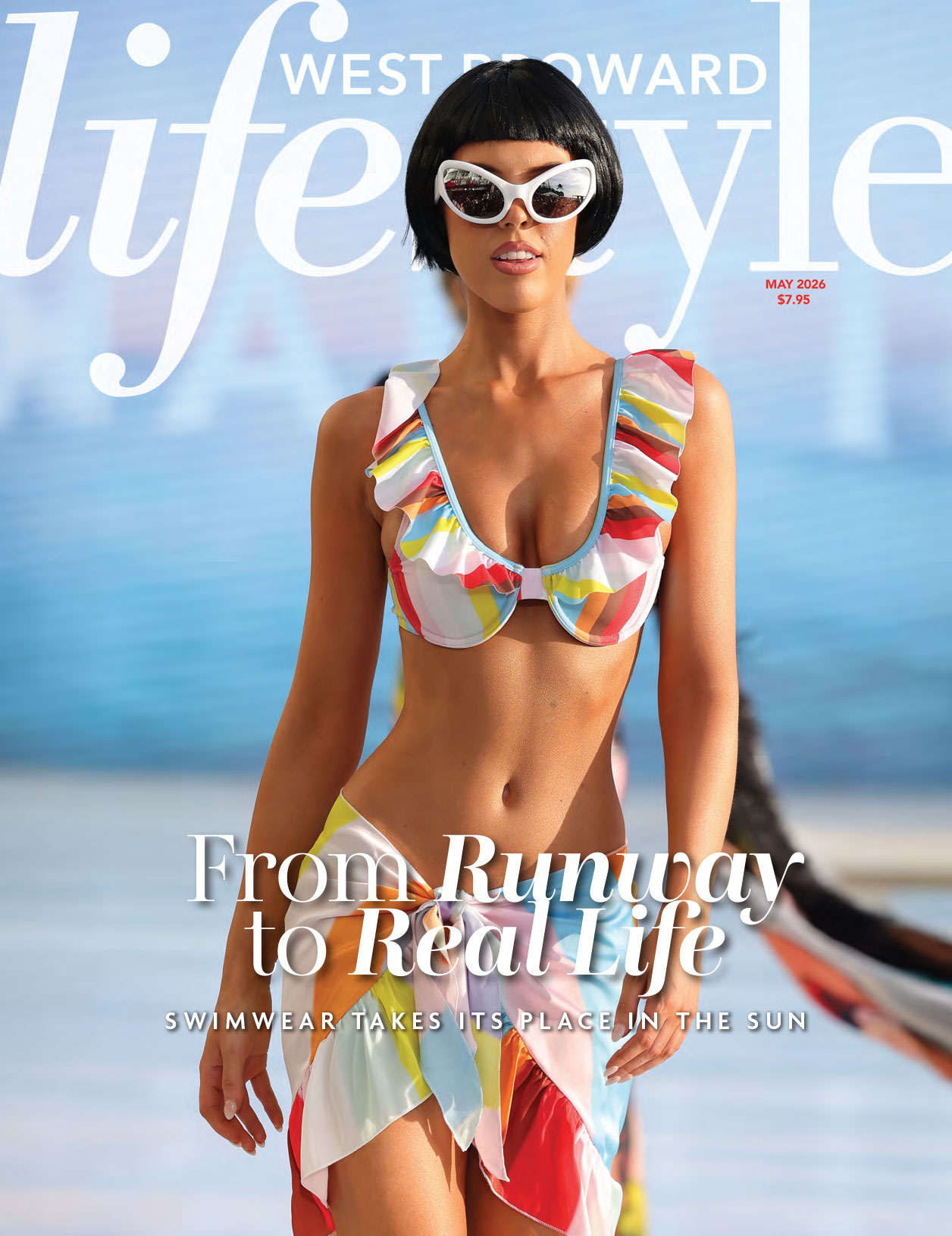A model in a colorful ruffled bikini and white sunglasses walks the runway on the May 2026 cover of West Broward Lifestyle magazine. The headline reads: “From Runway to Real Life: Swimwear Takes Its Place in the Sun.”. Lifestyle