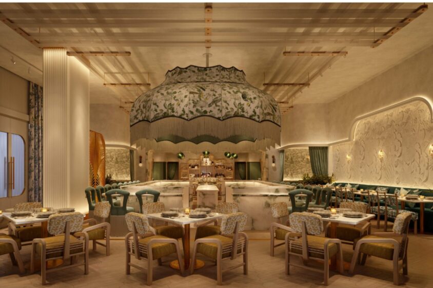 Elegant restaurant interior with soft lighting, green and beige tones, ornate central lampshade, curved bar, plush chairs, and wooden tables—perfect for savoring the April Flavor Files in a cozy, sophisticated atmosphere with decorative wall patterns. Lifestyle