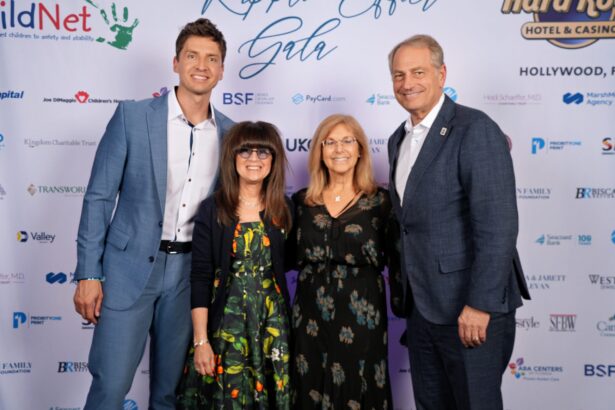 Four adults, two men in blue suits and two women in dresses, stand smiling together on the red carpet at the ChildNet Hosts Inaugural Ripple Effect Gala, posing before a white step-and-repeat event backdrop with multiple logos. Lifestyle