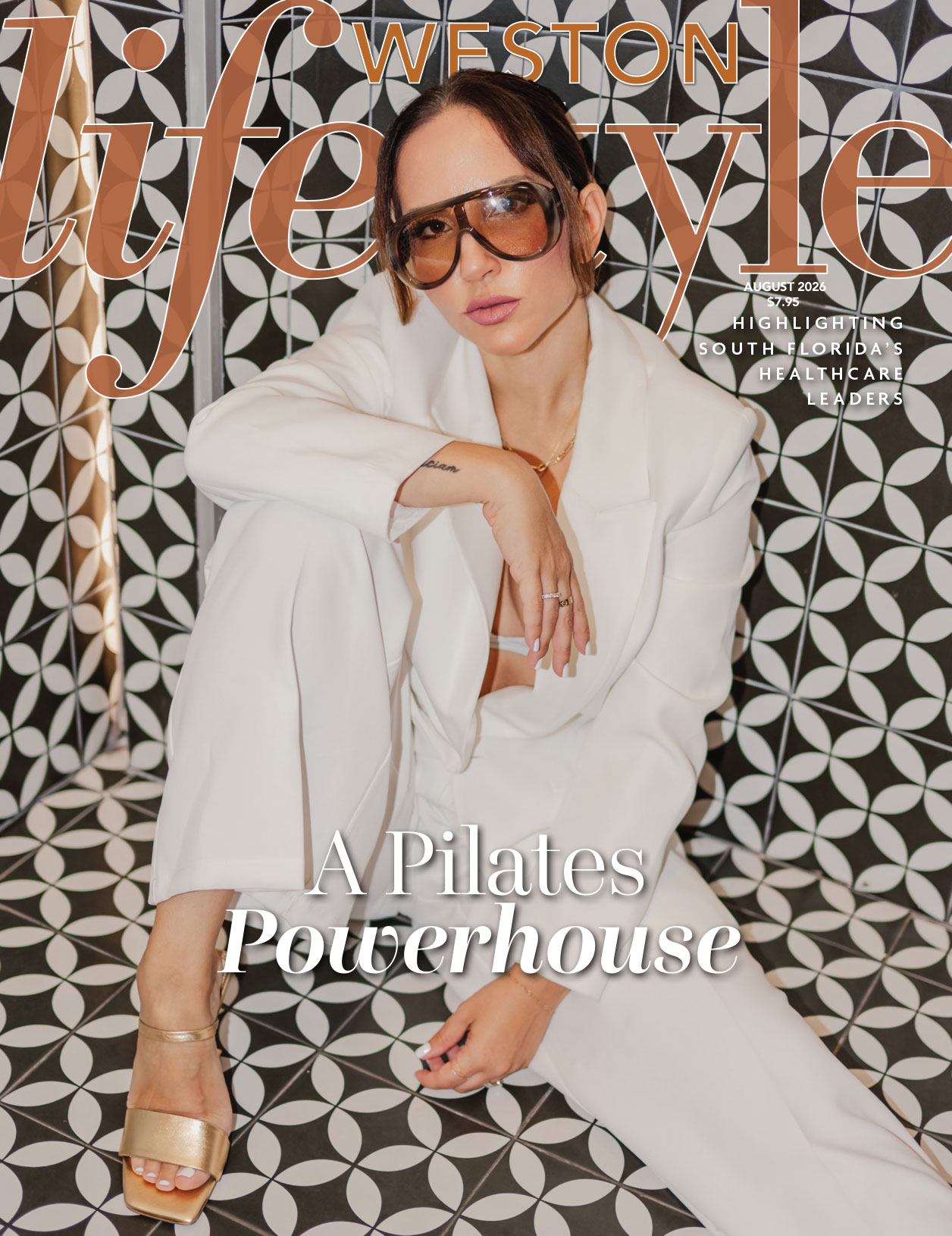 A woman in a white suit and gold heels sits on a patterned floor, wearing sunglasses. The text reads "Weston Lifestyle," "A Pilates Powerhouse," and highlights South Florida healthcare leaders. This sophisticated scene perfectly captures the spirit of Weston Lifestyle’s August 2026 edition. Lifestyle