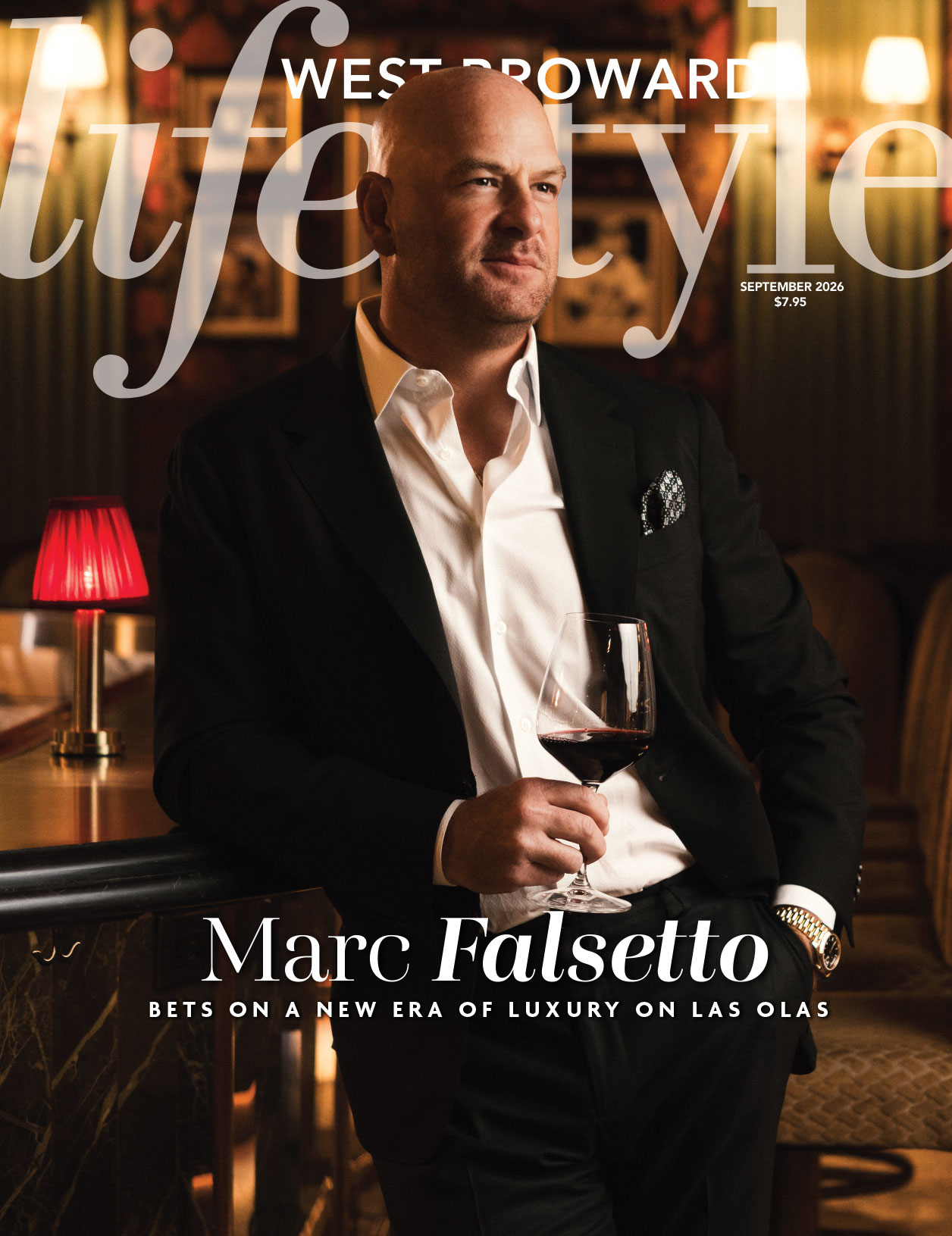 A well-dressed man in a suit leans on a bar, holding a glass of red wine. He is featured on the cover of West Broward Lifestyle magazine’s September 2026 issue, surrounded by elegant decor and warm lighting. Lifestyle